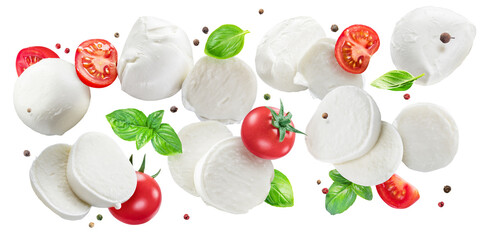 Flying slices of mozzarella cheese with cherry tomatoes, pepper and basil isolated on white...