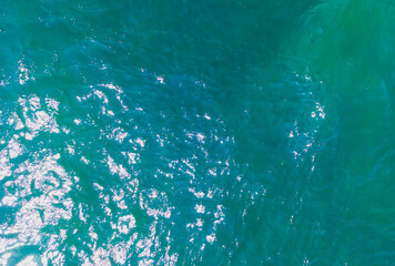 Aerial Drone photo. Beautiful turquoise green water background on summer sea beach. Relax and travel concept. Warm sunny weather.