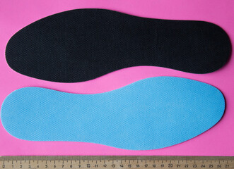 Blue insoles for shoes with ruler. Top view.