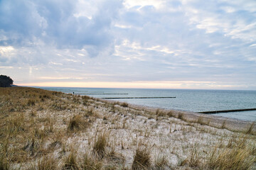 View over the dunes to the Baltic Sea at sunset. Vivid colors in the sky. Dune
