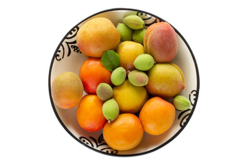 green fresh apricots and ripe apricots in the plate