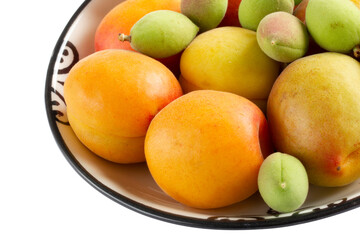 green fresh apricots and ripe apricots in the plate