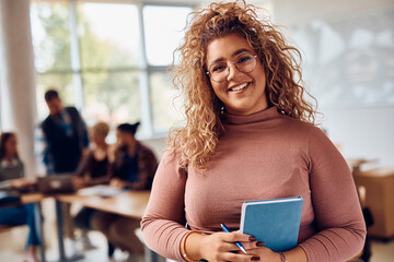 Portrait of happy female student at college classroom looking at camera. - obrazy, fototapety, plakaty