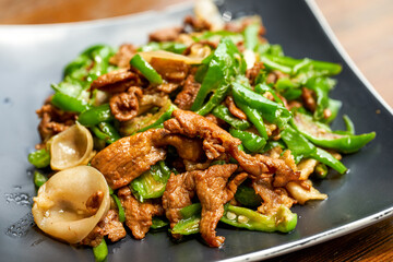 A plate of delicious and spicy Hunan dishes, fried pork with chili