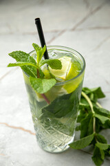 non-alcoholic cocktail, lemonade. With mint, ice, lime on a gray table