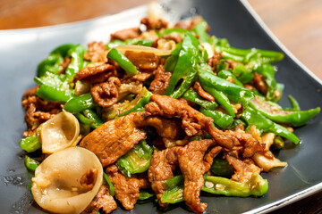 A plate of delicious and spicy Hunan dishes, fried pork with chili