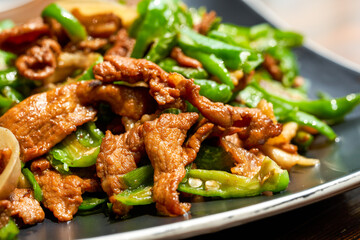 A plate of delicious and spicy Hunan dishes, fried pork with chili
