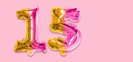 Rainbow foil balloon number, digit fifteen on a pink background. Birthday greeting card with inscription 15. Anniversary concept. Top view. Numerical digit. Celebration event, template. Banner