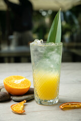non-alcoholic refreshing cocktail in the heat, lemonade. With ice on a gray table
