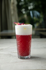 non-alcoholic refreshing cocktail in the heat, lemonade. With ice on a gray table
