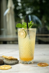 non-alcoholic cocktail, lemonade. With mint, ice, lime on a gray table