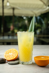 non-alcoholic refreshing cocktail in the heat, lemonade. With ice on a gray table
