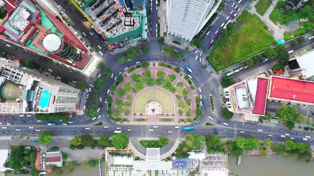 Time lapse Aerial city view, flying over a city, a suggestive perpendicular aerial video above a traffic roundabout with a lot of traffic, Vietnam Ho chi minh city. Timelapse
