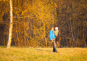 Adult man playing with a child outdoors in warm spring day.