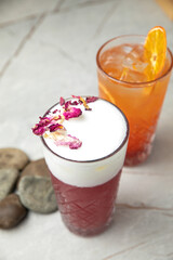 non-alcoholic refreshing cocktail in the heat, lemonade. With ice on a gray table
