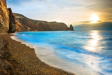 Sunset landscape above tropical sea and rocks