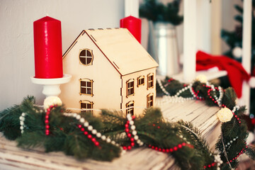 Christmas decoration in the form of a wooden house, gathered themselves.