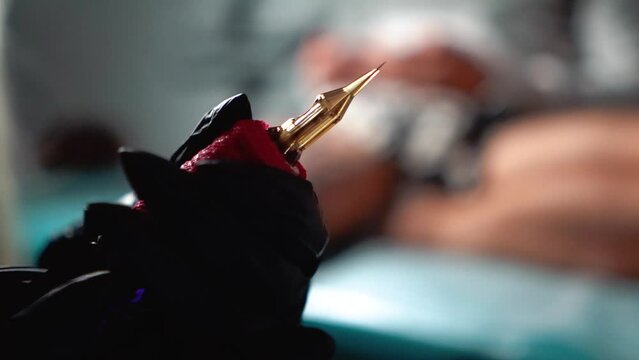 Close-up of a needle of a tattoo machine before starting a tattoo in a tattoo parlor