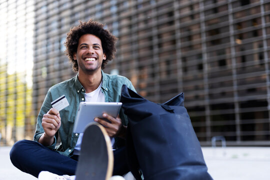 Man Buying Online With A Credit Card And A Digital Tablet