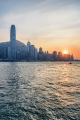 Victoria Harbor and skyscrapers in downtown at sunset, Hong Kong