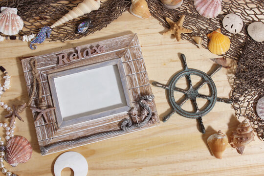 Empty Frame on Wooden Background With Sea Shells and Fishing Net. Nautical and Coastal Theme