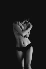 Naked woman on black background