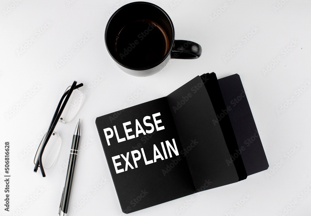 Aufkleber please explain written text in small black notebook with coffee , pen and glasess on white backgroun