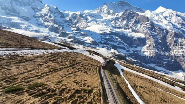 Jungfrau express, famous red mountain train in Switzerland, aerial view of glacier express in Swiss Alps, railway travel in Switzerland