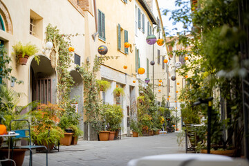 Fototapeta na wymiar Beautifully landscaped narrow street in the old town of Grosseto, in Maremma region of Italy. Cozy city view of the old Italian town