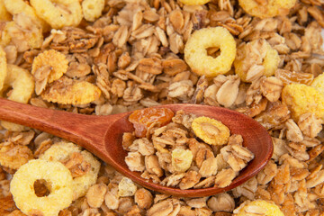 Oatmeal cereal breakfast in wooden spoon textured background