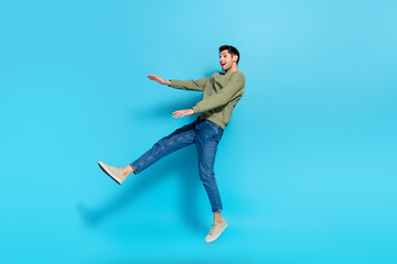 Full size photo of satisfied cheerful person falling jumping flight isolated on blue color background