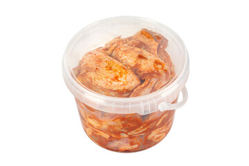 Raw marinated chicken wings in a plastic bucket