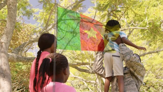 Animation of flag of cameroon over happy african american soldier father and family embracing