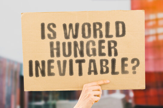 The question " Is world hunger inevitable? " is on a banner in men's hands with blurred background. African. Global. Help. Kid. Social. Support. Health. Life. Rice. Africa. Black. Problem. Empty