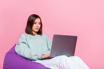 Photo of nice bob hairstyle young lady sit write laptop wear hoodie pants isolated on pink background