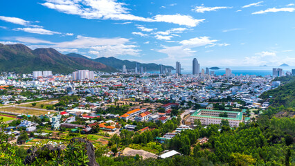 Fototapeta na wymiar The coastal city of Nha Trang seen from above on a sunny summer afternoon. This is a famous city for cultural tourism in central Vietnam