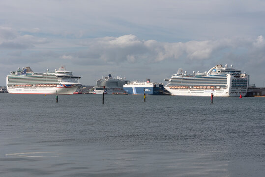 Southampton port, England, UK. Three cruise ships, Ventura, Iona, Emerald Princess and Garnet Leader a car carrier. Port of Southampton, UK. Ventura is underway.