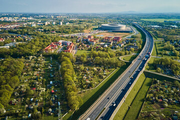 Aerial view of Wroclaw cityscape with residential districts, stadium and car traffic road
