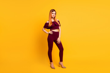 Full body portrait of calm stunning girl put arm waist posing isolated on yellow color background