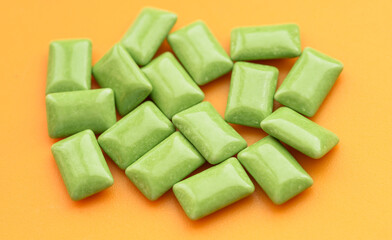 Candy or pills on orange background.