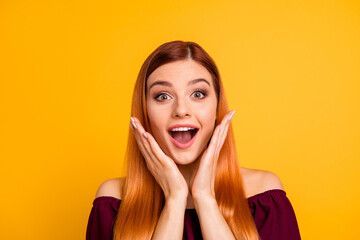 Photo of impressed speechless girl raise hands open mouth stare cant believe isolated on yellow color background