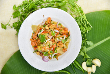 Spicy Salad with Porridge - Thai food, top view on white background.