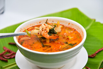 Spicy Seafood Soup - Thai food, top view on white background.