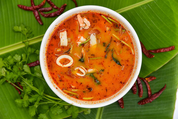 Spicy Seafood Soup - Thai food, top view on white background.