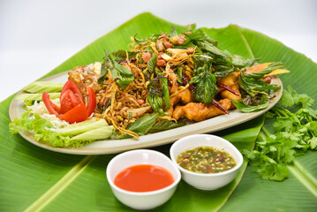 Deep-fried Red Tilapia Fish with Thai Herbs - Thai food, top view on white background.