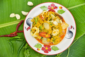 Stir-fried Squid with Curry Powder - Thai food, top view on white background.