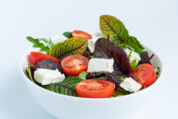 Caesar salad on black plate isolated on white