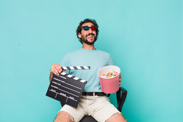 young adult hispanic crazy man. cinema clapper and pop corns. movie concept