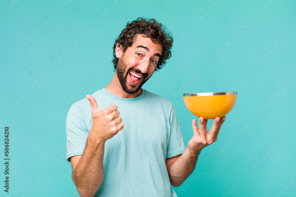 Sticker young adult hispanic crazy man holding an empty bowl