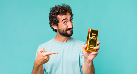 young adult hispanic crazy man holding a gold ingot